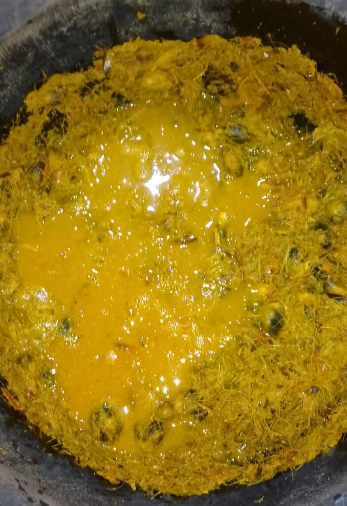 pounded-palm-fruits-melted-in-warm-water-inside-the-mortar