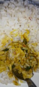 stew-and-rice-stirred-with-a-spoon-in-a-plate